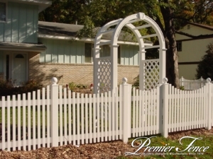 Vinyl picket fence with an arbor