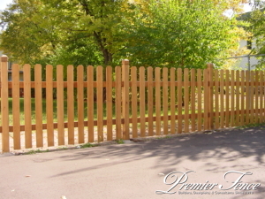 western red cedar picket fence for containment with dog eared boards installed in driveway