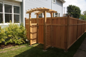 SONY DSC Wood privacy fence around backyard with large wood arbor at gate entrance