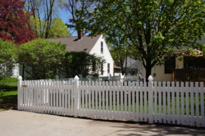 Digger Specialties Inc White Superior Style vinyl picket fence around front yard for security and boundary
